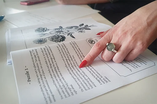 A finger tracing the text of Puzzle 1